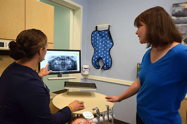 A doctor explaining a dental x-ray to a patient